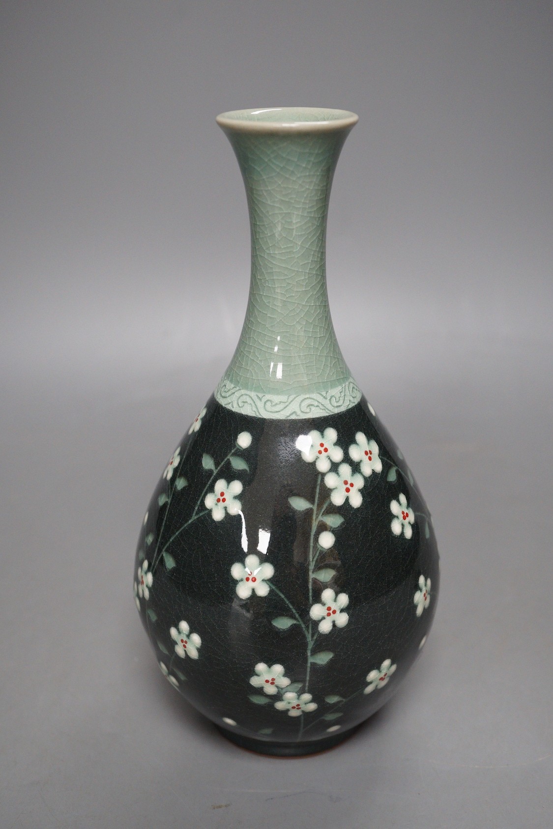 A Korean celadon ground floral decorated bottle vase, 20.5cm